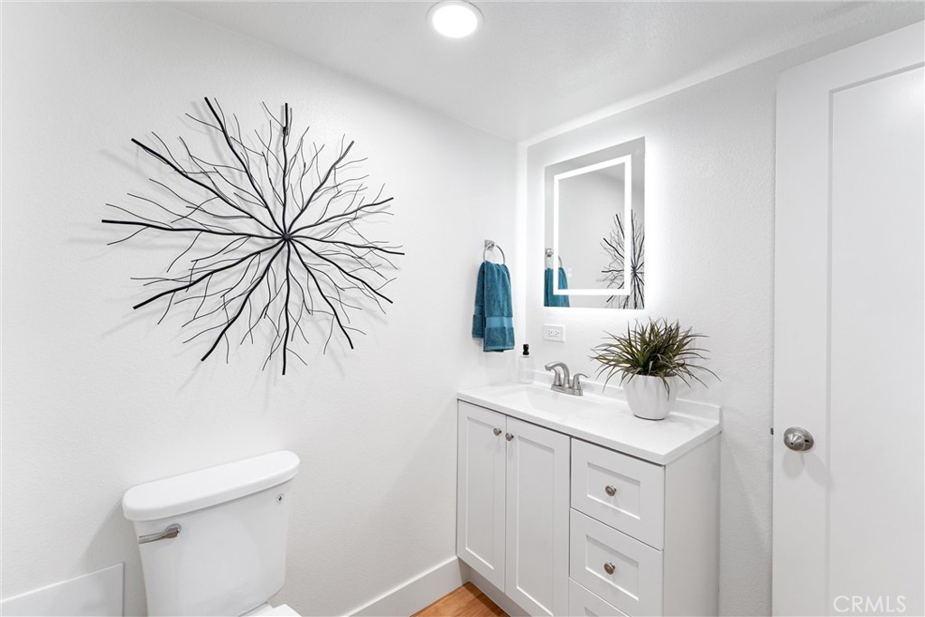 8236 Henderson Green Buena Park, CA 90621 - Photo 16 of 35 a bathroom with a sink a toilet and mirror