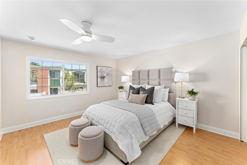 8236 Henderson Green Buena Park, CA 90621 - Photo 17 of 35 a bedroom with a bed and a large window