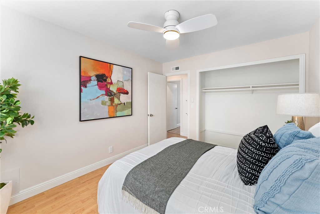 8236 Henderson Green Buena Park, CA 90621 - Photo 21 of 35 a bedroom with a large bed and a chandelier