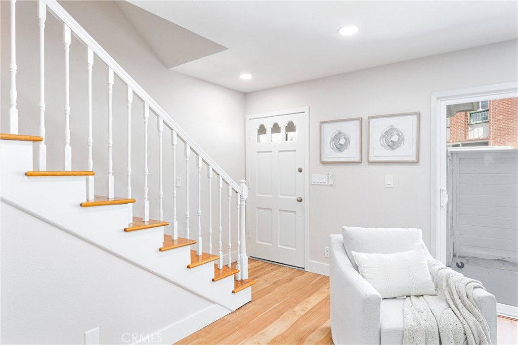 8236 Henderson Green Buena Park, CA 90621 - Photo 3 of 35 a view of staircase with lots of frames on wall and a large window