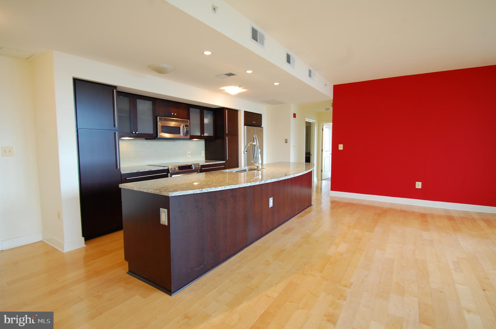 675 President Street, Unit 1609 Baltimore, MD 21202 - Photo 3 of 13 a kitchen with stainless steel appliances granite countertop a sink a stove top oven and a refrigerator