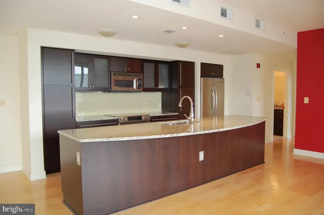 a bathroom with double sink and a mirror