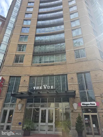 a spacious bedroom with a bed and large window