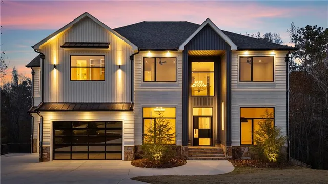 a front view of a house with a yard and garage