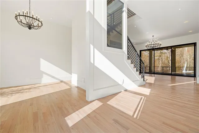 a view of a hallway with wooden floor and staircase