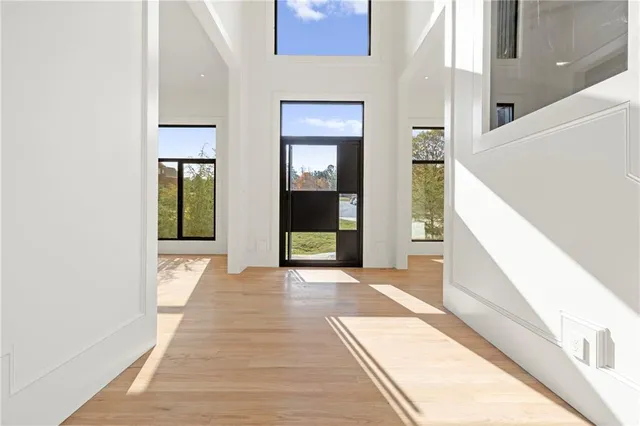 a view of a living room and kitchen with wooden floor