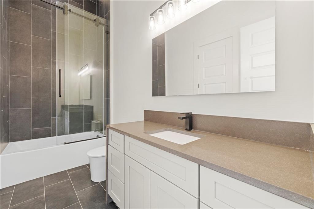 520 Heathmill Court Milton, GA 30004 - Photo 20 of 84 a bathroom with a granite countertop sink a toilet and bathtub