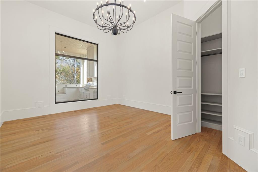 520 Heathmill Court Milton, GA 30004 - Photo 21 of 84 an empty room with wooden floor cabinet and windows