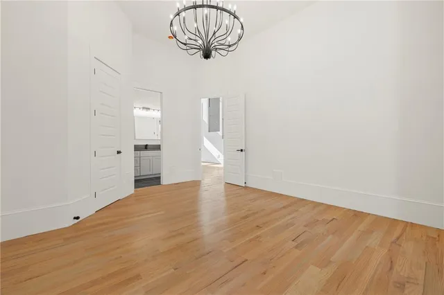 a kitchen with granite countertop a stove a sink and a wooden cabinets