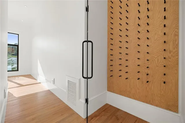 a view of a room with wooden floor and window