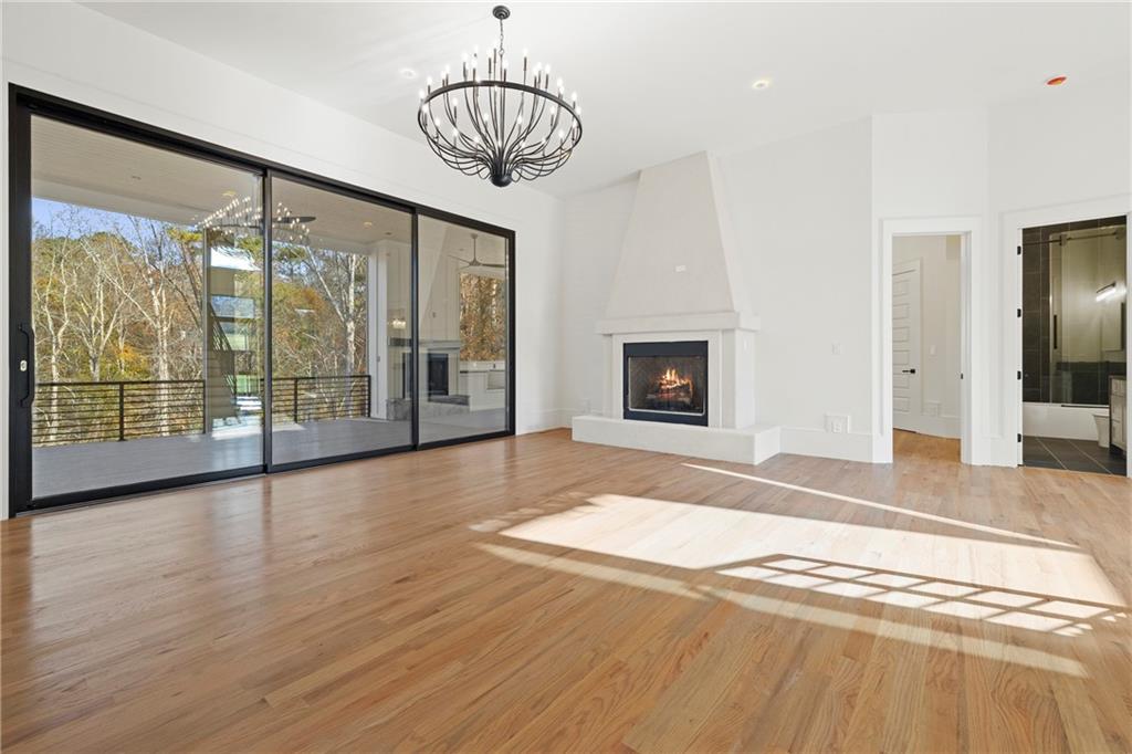 520 Heathmill Court Milton, GA 30004 - Photo 26 of 84 a view of livingroom with furniture wooden floor and chandelier