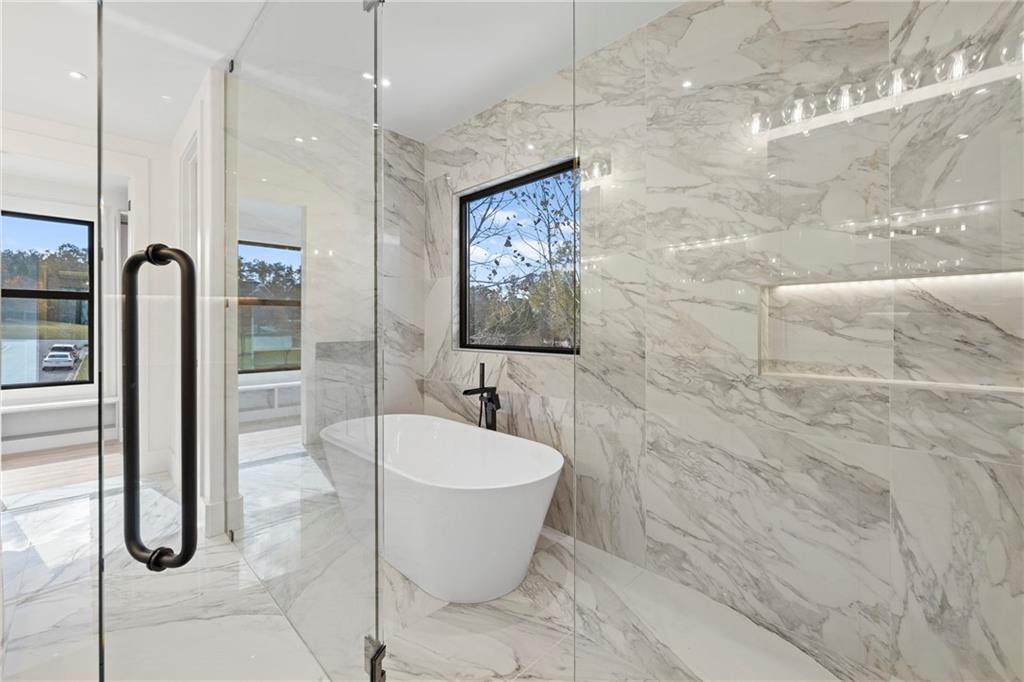 520 Heathmill Court Milton, GA 30004 - Photo 46 of 84 a bathroom with a bathtub and shower