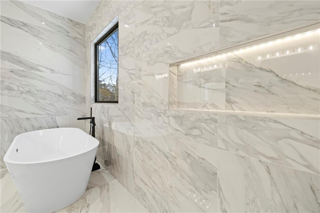520 Heathmill Court Milton, GA 30004 - Photo 47 of 84 a bathroom with a bathtub and shower