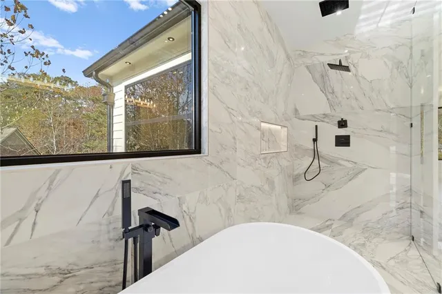 a view of a house with wooden door and a yard