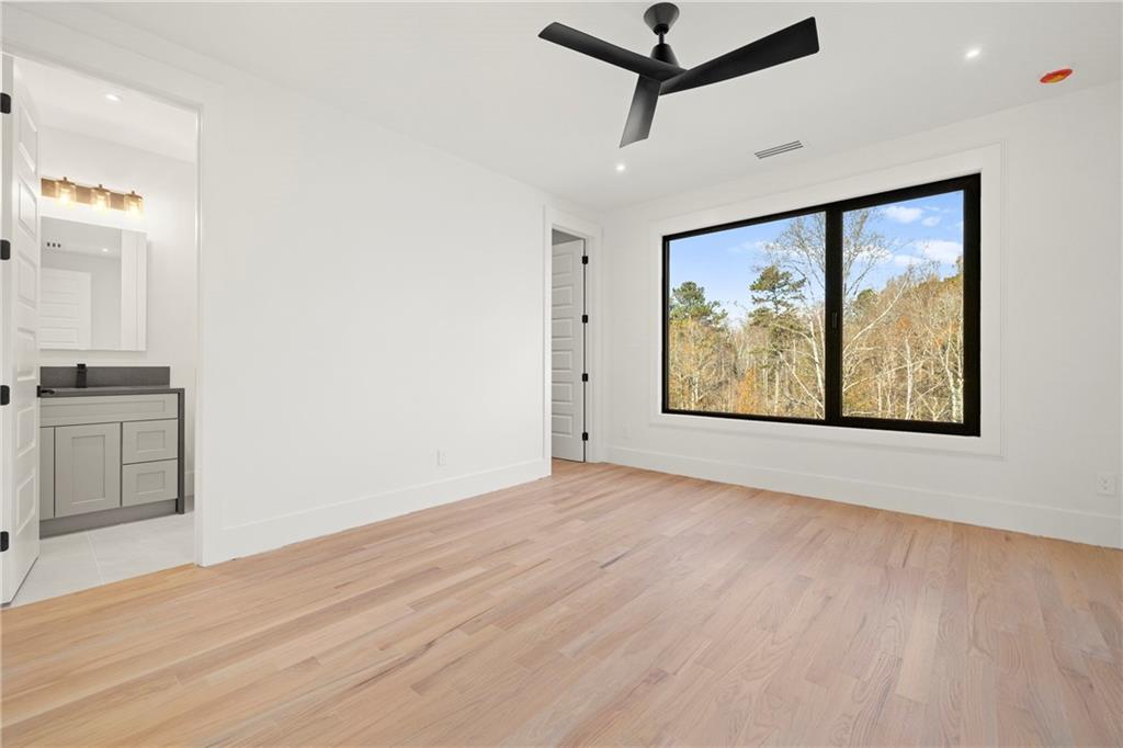 520 Heathmill Court Milton, GA 30004 - Photo 51 of 84 a view of an empty room with a window and wooden floor