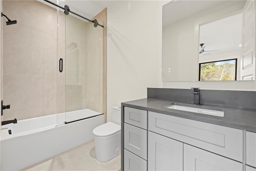 520 Heathmill Court Milton, GA 30004 - Photo 55 of 84 a bathroom with a granite countertop sink toilet and shower