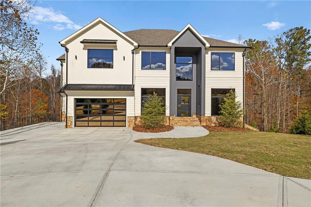 520 Heathmill Court Milton, GA 30004 - Photo 6 of 84 a front view of a house with a yard and garage