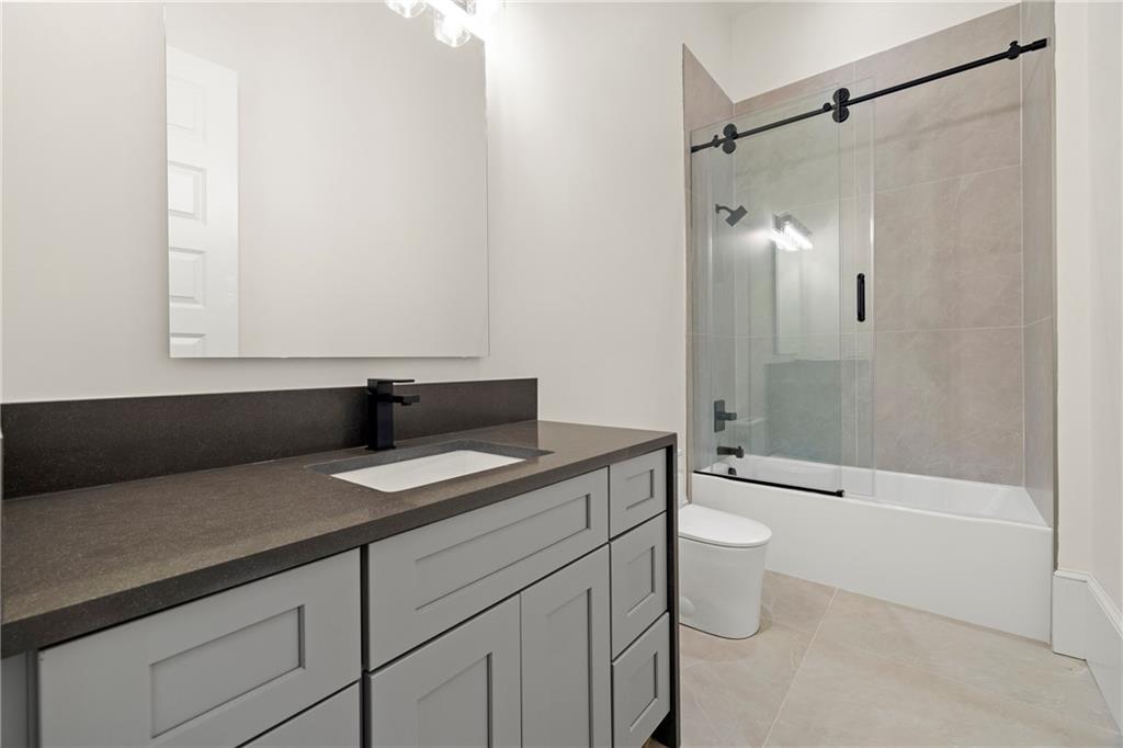 520 Heathmill Court Milton, GA 30004 - Photo 63 of 84 a bathroom with a granite countertop sink toilet and shower