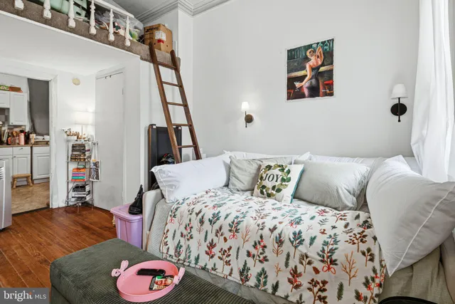 a bedroom with a bed and a couch