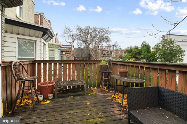 a view of a deck with chairs next to yard