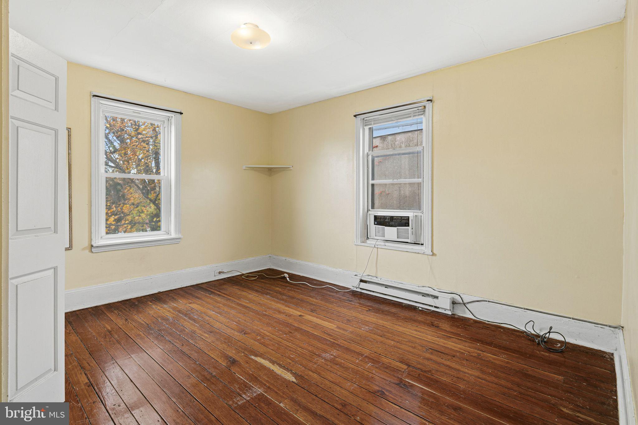 2914 Poplar Street Philadelphia, PA 19130 - Photo 20 of 32 a view of an empty room with wooden floor and a window