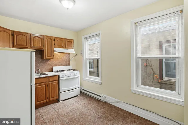 a kitchen with a stove a sink and a refrigerator