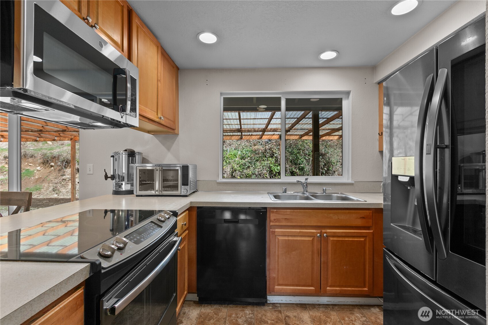 22731 Prairie Road Sedro-Woolley, WA 98284 - Photo 12 of 37 a kitchen with stainless steel appliances granite countertop a stove a sink and a microwave