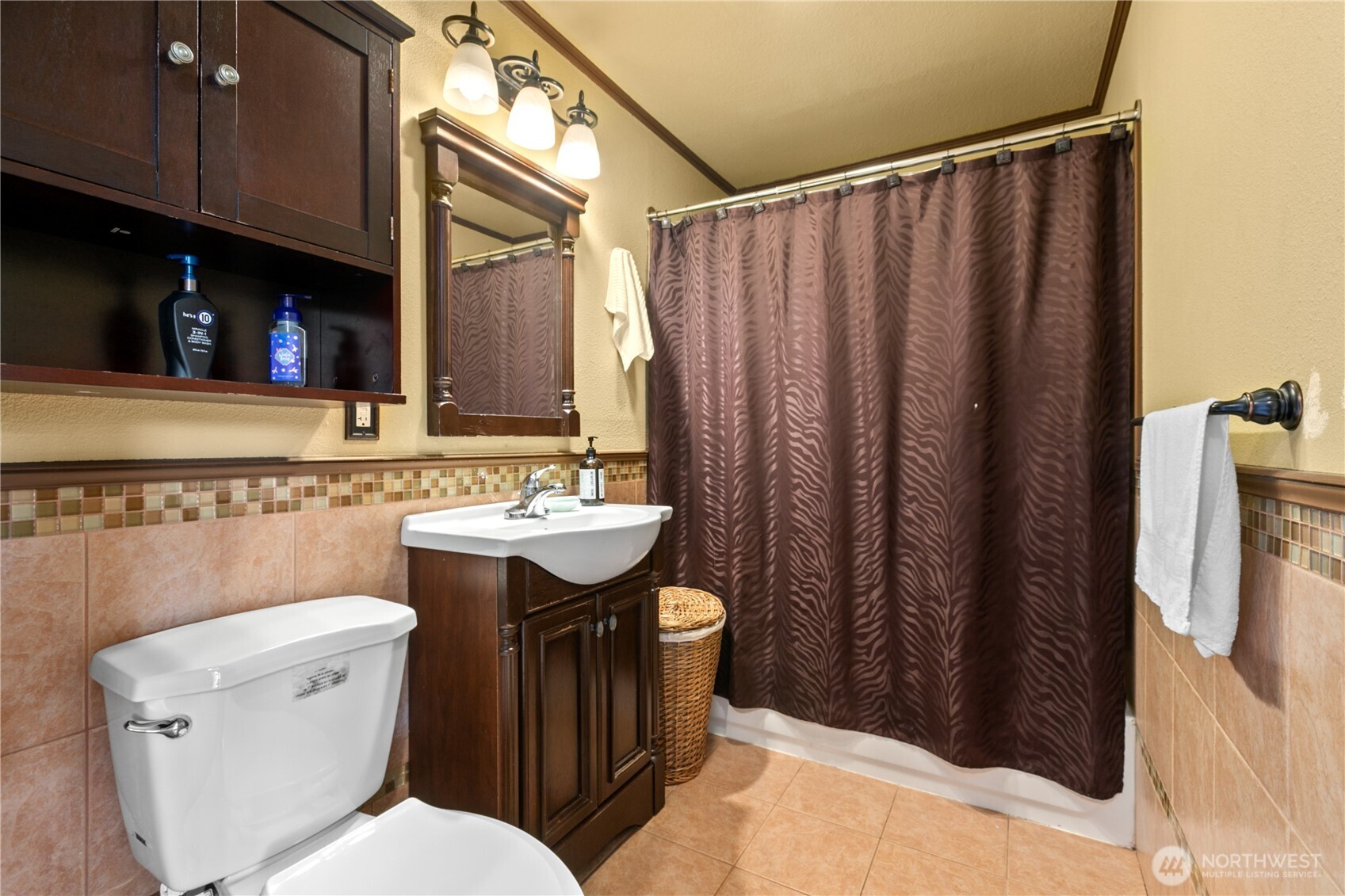 22731 Prairie Road Sedro-Woolley, WA 98284 - Photo 23 of 37 a bathroom with a sink a toilet a mirror and shower curtain