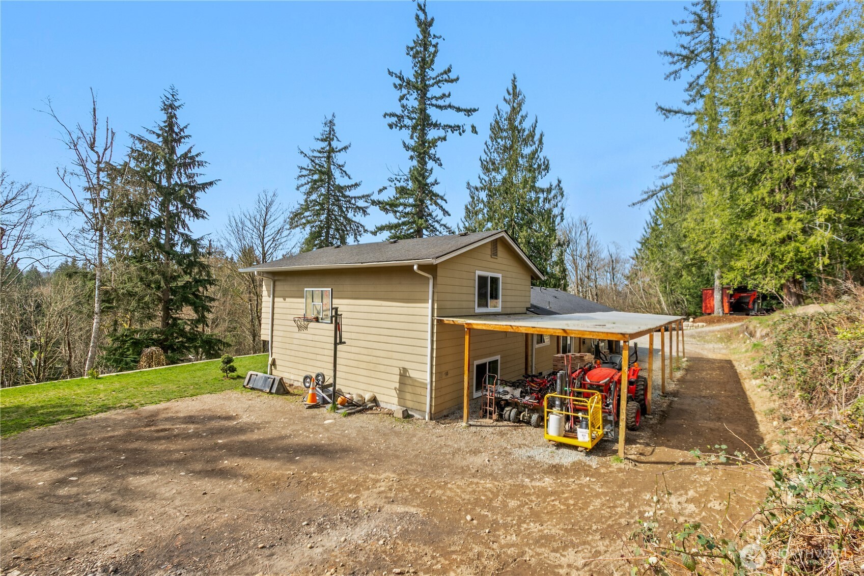 22731 Prairie Road Sedro-Woolley, WA 98284 - Photo 25 of 37 a view of a wooden house with large trees and playing area