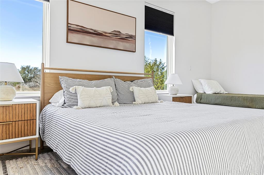 1166 Big Bear Loop Carbon, TX 76435 - Photo 13 of 39 a bedroom with a bed and a painting on the wall