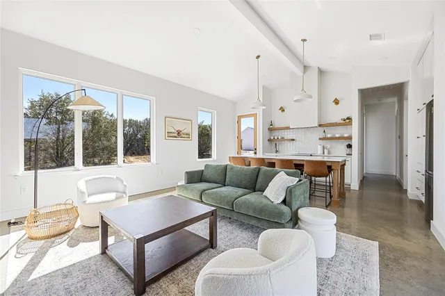 a dining room with kitchen island a table and chairs in it