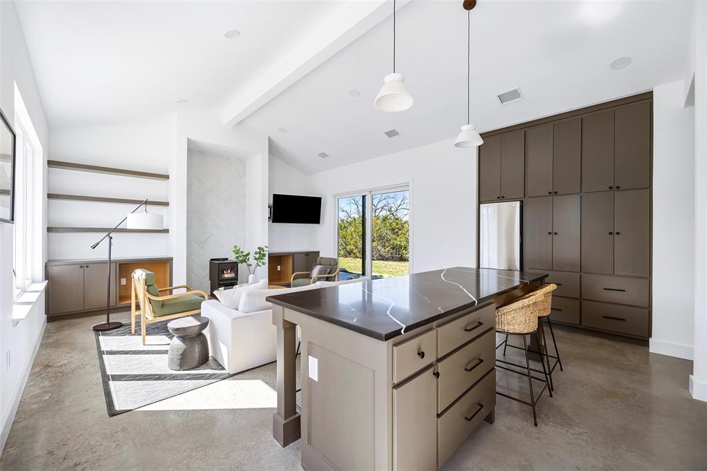 1166 Big Bear Loop Carbon, TX 76435 - Photo 24 of 39 a kitchen with a stove a refrigerator and a table