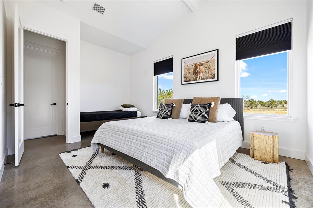 1166 Big Bear Loop Carbon, TX 76435 - Photo 31 of 39 a bedroom with a bed and a table