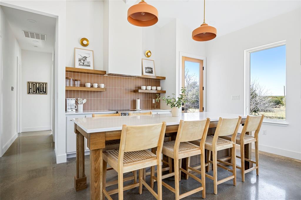 1166 Big Bear Loop Carbon, TX 76435 - Photo 10 of 39 a view of a dining room with furniture and wooden floor