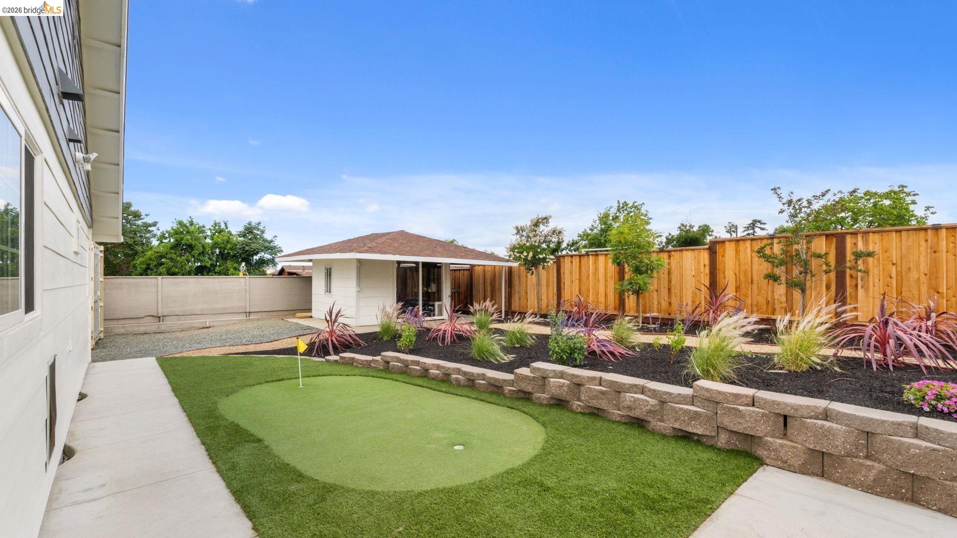 700 Brownstone Road Oakley, CA 94561 - Photo 37 of 58 Putting green with artificial turf, bordered by a concrete walkway