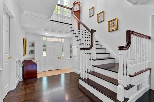 a view of entryway with wooden floor and stairs