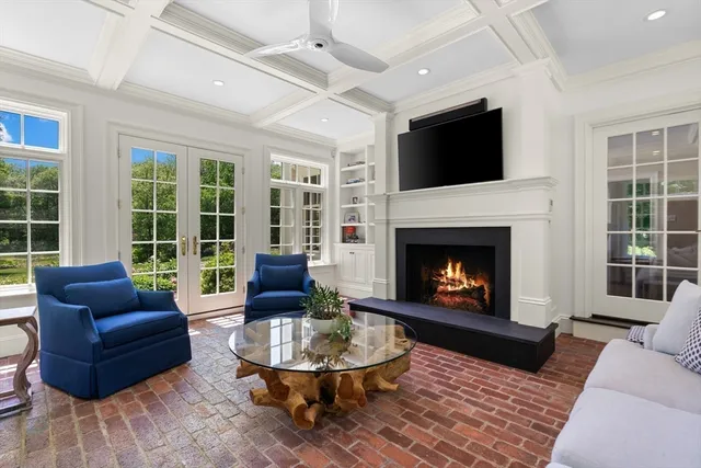 a living room with furniture a fireplace and a flat screen tv