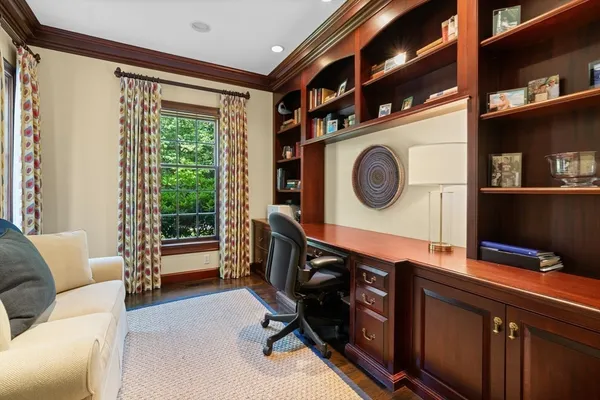 a living room with furniture and a clock