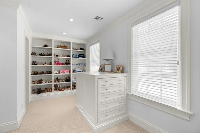 a view of walk in closet with empty racks