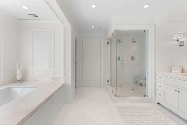 a bathroom with a bathtub and shower
