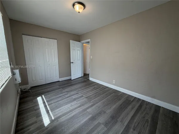 a view of room with wooden floor