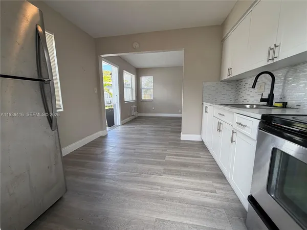 a kitchen with sink and refrigerator