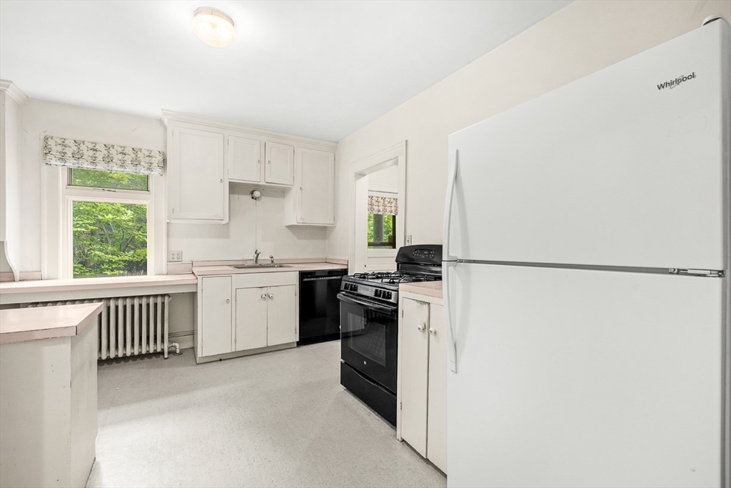 30 Rangeley Road Winchester, MA 01890 - Photo 17 of 42 a kitchen with a refrigerator stove and white cabinets