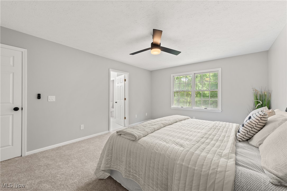 8080 Fair Road Strongsville, OH 44149 - Photo 25 of 50 Carpeted bedroom featuring baseboards, ceiling fan, and ensuite bathroom