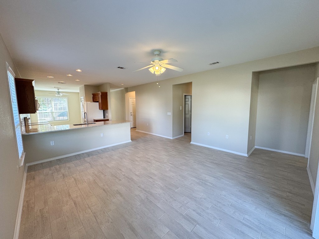 100 Sunbird Court Georgetown, TX 78633 - Photo 16 of 40 Unfurnished living room featuring light wood-type flooring, ceiling fan, and recessed lighting