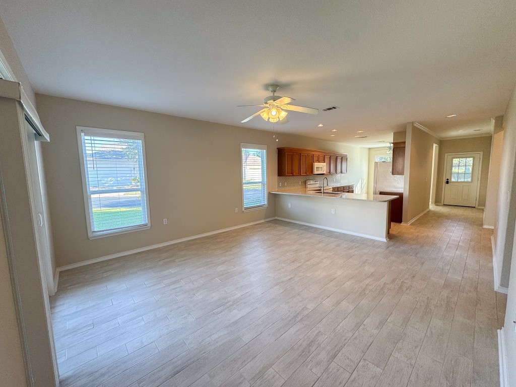 100 Sunbird Court Georgetown, TX 78633 - Photo 18 of 40 Unfurnished living room featuring light wood-style flooring and ceiling fan