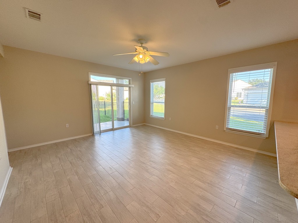 100 Sunbird Court Georgetown, TX 78633 - Photo 19 of 40 Spare room with healthy amount of natural light, light wood finished floors, and a ceiling fan