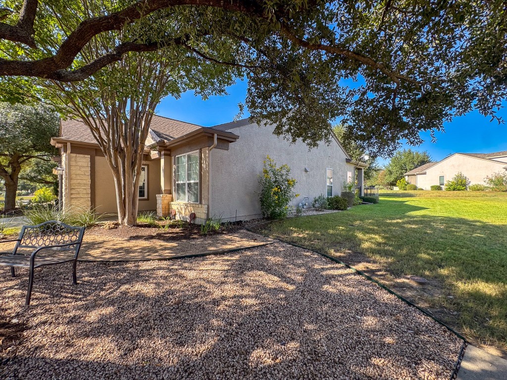 100 Sunbird Court Georgetown, TX 78633 - Photo 5 of 40 View of home's exterior featuring stucco siding and a lawn
