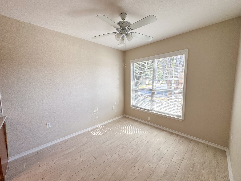 100 Sunbird Court Georgetown, TX 78633 - Photo 8 of 40 Unfurnished room with light wood-type flooring and a ceiling fan
