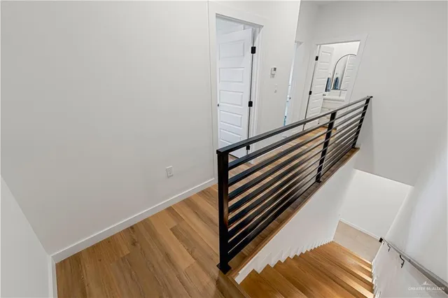 a bedroom with a bed and a lamp on the dresser